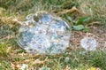 A large bubble sits on the grass, surrounded by smaller bubbles Royalty Free Stock Photo