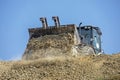 Large bucket of an escalator with soil frontally on a sunny hot day against the sky. Global construction. Mining, salt