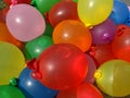 A large bucket full of colourful water balloons bombs Royalty Free Stock Photo