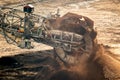 Large bucket wheel excavator mining machine at work in a brown coal open pit mine