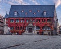 a large building with red ivys on it in the foreground