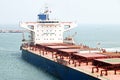 A large bulk carriers, tugboats at the port under cargo operations and underway. Close-up view of ships constructions and equipmen