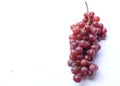 Flat lay   A bunch of black and purple grapes with fresh green isolate on a white background. Royalty Free Stock Photo