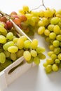 Closeup of green grapes in a wooden box on white background Royalty Free Stock Photo