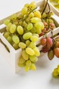 Closeup of green grapes in a wooden box on white background Royalty Free Stock Photo