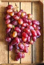 A large bunch of ripe grapes on a background of a dark textured wooden table. Grapes closeup and copy space. Royalty Free Stock Photo