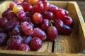 A large bunch of ripe grapes on a background of a dark textured wooden table. Grapes closeup and copy space. Royalty Free Stock Photo