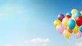 A large bunch of yellow Helium ballons straining on their strings against a sunny sky with white clouds Royalty Free Stock Photo