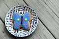 Large butterfly cookie frosted in bright colors, set on pretty plate