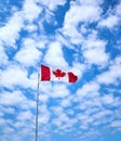 Large Canadian Flag flying against  blue sky background Royalty Free Stock Photo