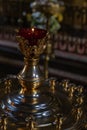 A large candle holder with a lamp in an Orthodox church