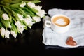 Cup of cappuccino and tulips.