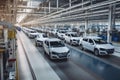 large car factory, with rows of newly assembled vehicles on the assembly line