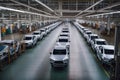 large car factory, with rows of newly assembled vehicles on the assembly line