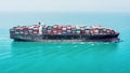 Large cargo container ship sailing on the turquoise ocean Royalty Free Stock Photo