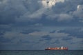 Large cargo ship on top of the horizon at dusk Royalty Free Stock Photo