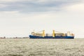 Large cargo ship for transportation import export goods is carrying a big propeller of wind power station during sailed in the Royalty Free Stock Photo