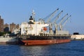 A large cargo ship unloads cement at Brooklyn Navy Yard Pier K