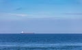 Large cargo tanker sailing across a blue sea