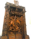 Large, carved door with wood and metal statues