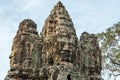 Large carved stone heads in Bayon temple in Angkor Archaeological Park, Siem Reap, Cambodia