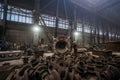 Large cast iron product moved on girder crane in workshop of metallurgical plant. Foundry, Heavy industry, production of