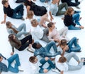 Large casual group of young people sitting on the floor.