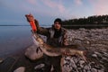 large caught pike fish in hands of male fisherman on lake shore Royalty Free Stock Photo