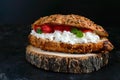 Large cereal croissant with cottage cheese and fresh strawberries on a dark background. Tasty breakfast. Royalty Free Stock Photo