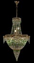 Large chandelier with green crystals isolated on black background. Royalty Free Stock Photo