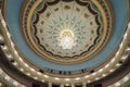 Large chandelier hangs on the theater hall decorated ceiling Royalty Free Stock Photo