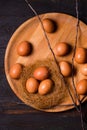 Large chicken eggs on a wooden plate