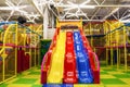 Large children`s playroom with a slide and colorful balls in entertainment center