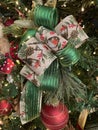 Large Christmas bow made with woodland and green ribbon