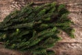 Large Christmas fir branch on a wooden holiday background. Xmas and New Year theme. Flat lay