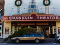 Large Christmas Tree on Top of Small Car