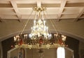 Large church chandelier with gold plating and burning candles