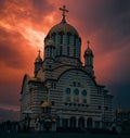 a large church with many spires and a red sky