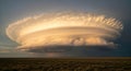 Large Circular Cloud Formation Over Flat Landscape During Sunset Royalty Free Stock Photo