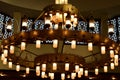 A large circular mosque chandelier ceiling light with lamps and made of copper and other metals fixed to the large mosque masjid