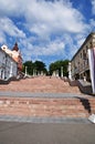 Large city staircase with beautiful lanterns. View of the stairs and old stone houses.