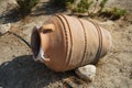 A large clay pot or amphora lies as decoration in the garden. Lardos, Rhodes Island, South Aegean region, Greece Royalty Free Stock Photo