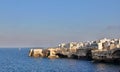 large cliff on the seashore, rocks by the sea, buildings built on the rocks right on the seashore, Polignano a Mare, rocky coast Royalty Free Stock Photo