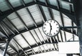 Large clock on the train station. Railway station clock hanging onto the roof