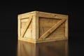 Large closed wooden box isolated on a dark background with reflection