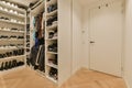 a large closet filled with shoes and a white door Royalty Free Stock Photo