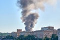 Large clouds of dark smoke over the rooftops of residential buildings. A strong fire in Moscow, a warehouse with pyrotechnics is