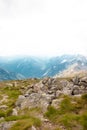 Large cobble stones on the hillside. Landscape with green blue mountains, hills and clouds in the sky, scenic outdoor Royalty Free Stock Photo