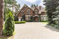 Large cobbled driveway in front of an impressive red brick English design mansion surrounded by old trees Royalty Free Stock Photo