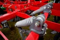 Large coil springs on modern farming machinery.